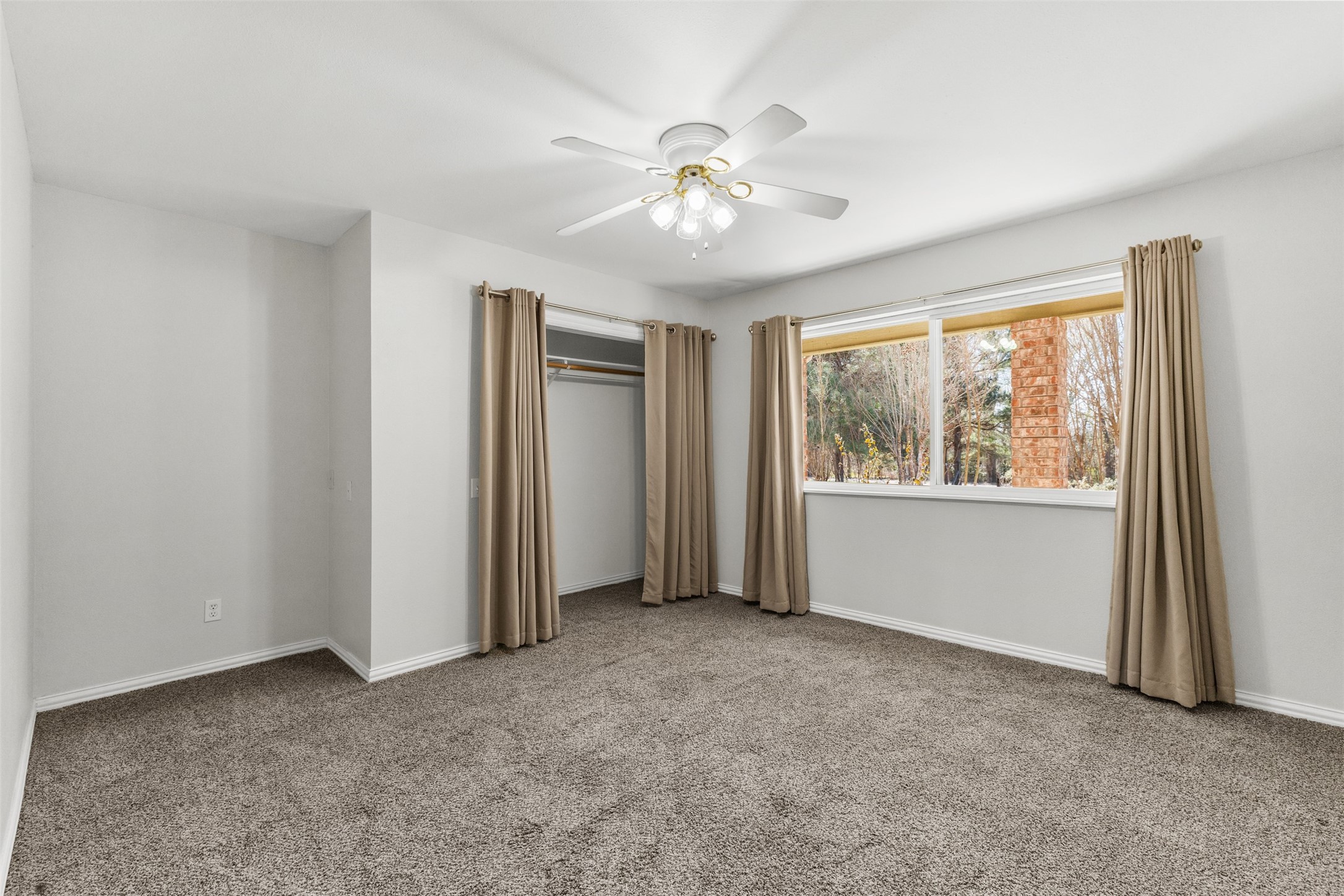 10860 County Road 272 Somerville, TX 77879 - Photo 16 of 34 a view of an empty room with chandelier fan and fire place
