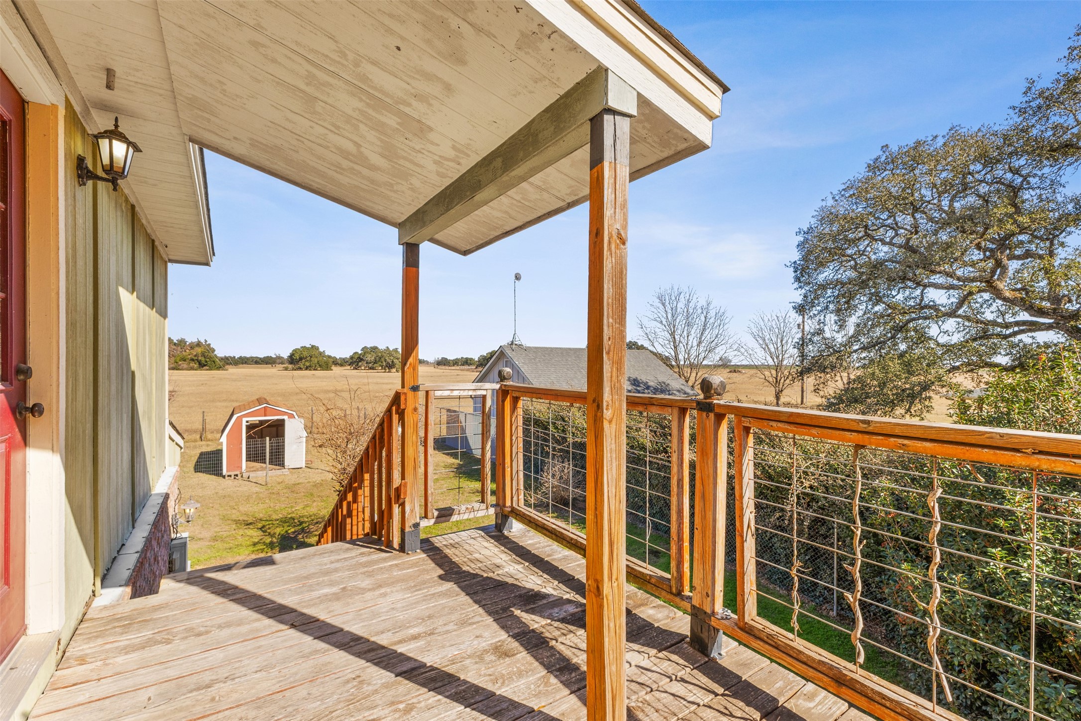 10860 County Road 272 Somerville, TX 77879 - Photo 24 of 34 a view of a balcony with a floor to ceiling window with wooden floor