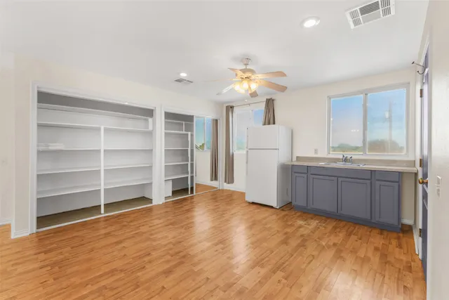 a view of a kitchen with a sink and a refrigerator