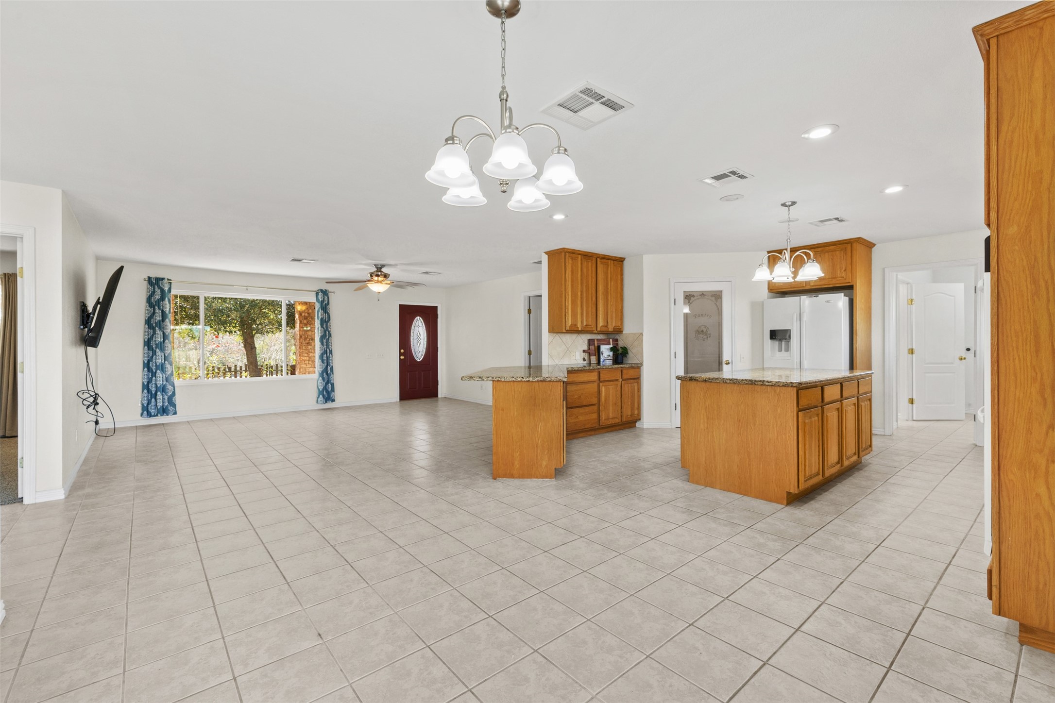 10860 County Road 272 Somerville, TX 77879 - Photo 5 of 34 a view of a kitchen with kitchen island stainless steel appliances granite countertop a stove and a sink with chandelier