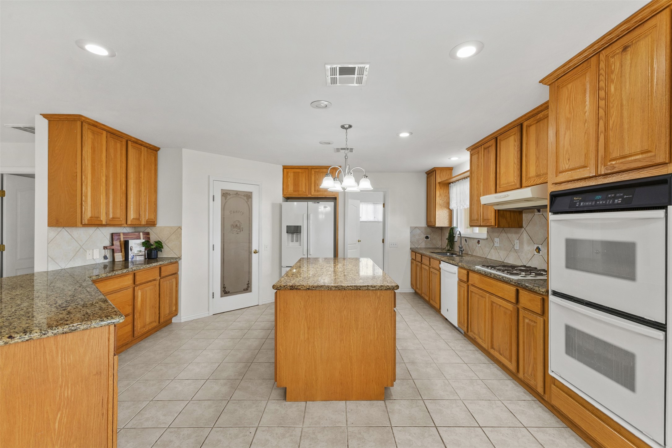 10860 County Road 272 Somerville, TX 77879 - Photo 7 of 34 a large kitchen with stainless steel appliances granite countertop a stove refrigerator and a sink