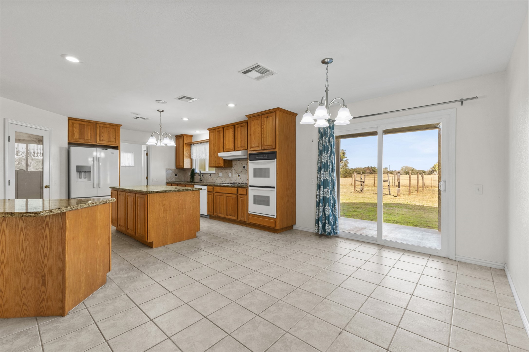 10860 County Road 272 Somerville, TX 77879 - Photo 9 of 34 a view of a kitchen with furniture and an empty room