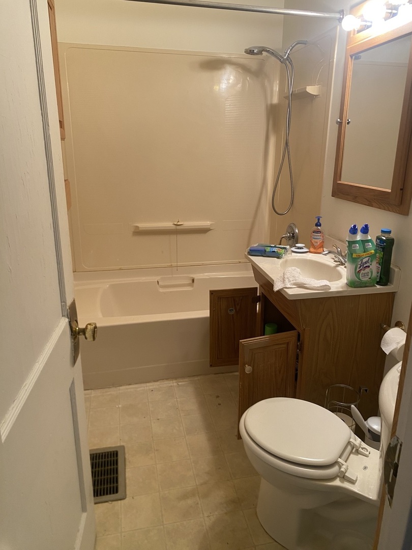 414 Hovey Avenue Normal, IL 61761 - Photo 6 of 9 a bathroom with a sink a toilet and shower