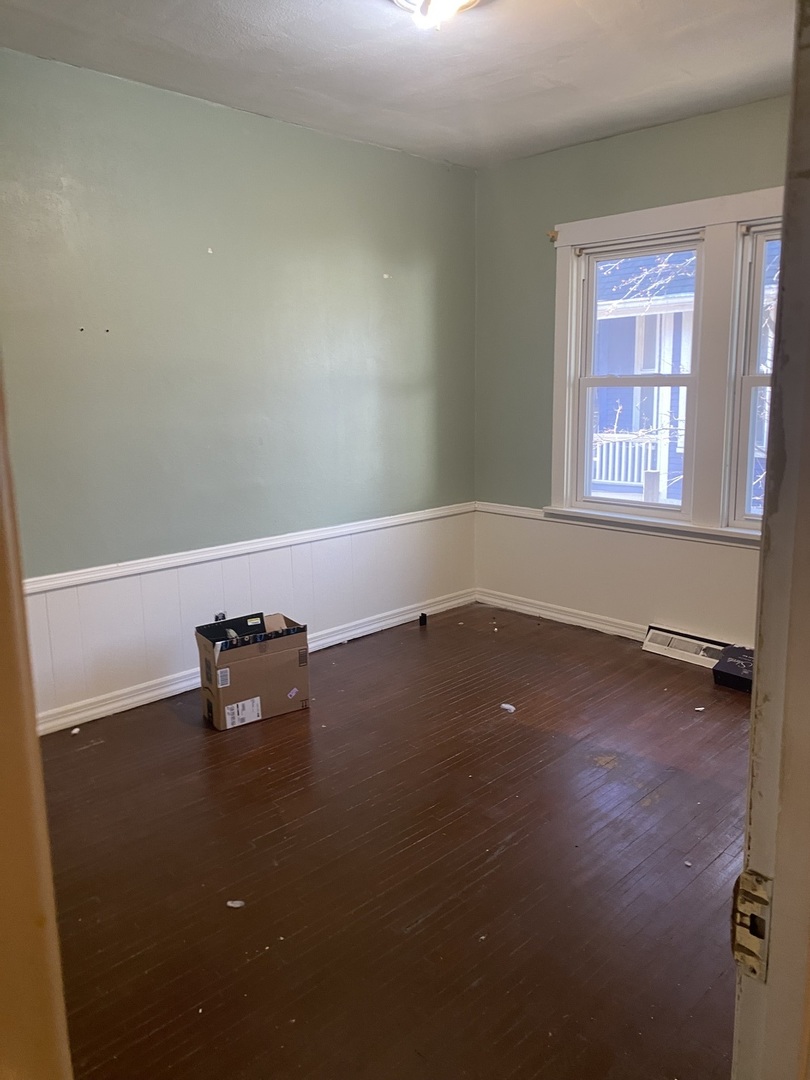 414 Hovey Avenue Normal, IL 61761 - Photo 8 of 9 an empty room with wooden floor and windows