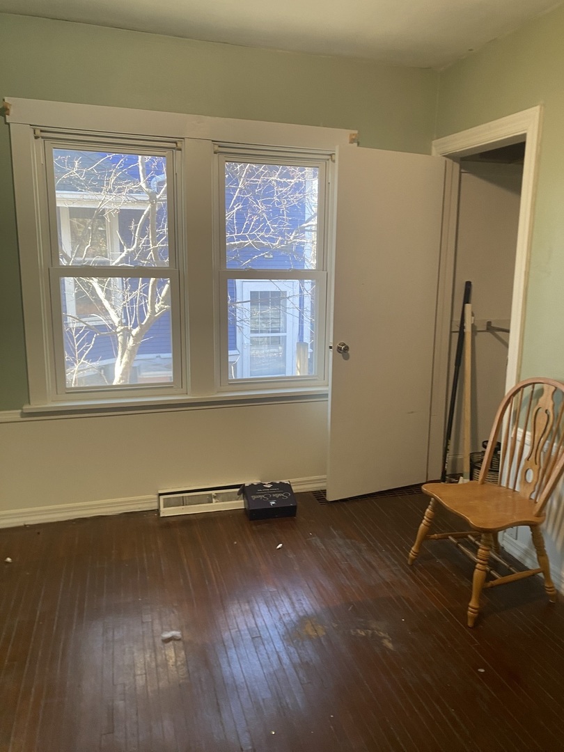 414 Hovey Avenue Normal, IL 61761 - Photo 9 of 9 a view of an empty room with wooden floor and a window