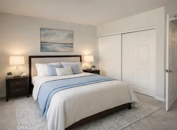 a bedroom with a bed and a painting on the wall