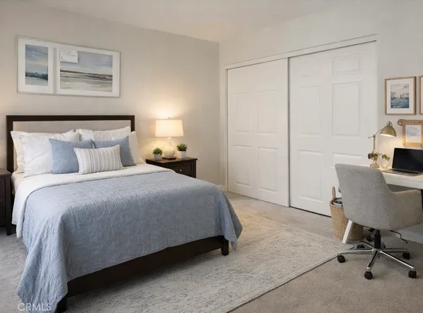 a bedroom with a bed a table and chair