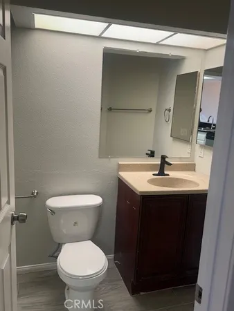 a bathroom with a toilet sink and mirror