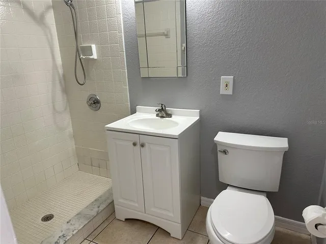 a white toilet sitting next to a bathroom sink