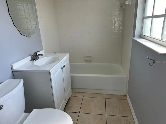 a bathroom with a sink toilet and tub