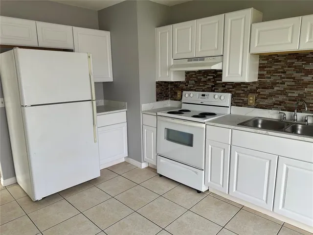 a white refrigerator freezer sitting in a kitchen