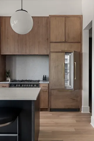 a kitchen with a sink cabinets and wooden floor