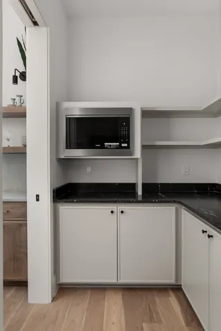 a bathroom with a shower sink and mirror