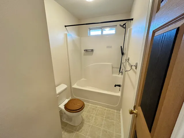 a bathroom with a shower and a toilet