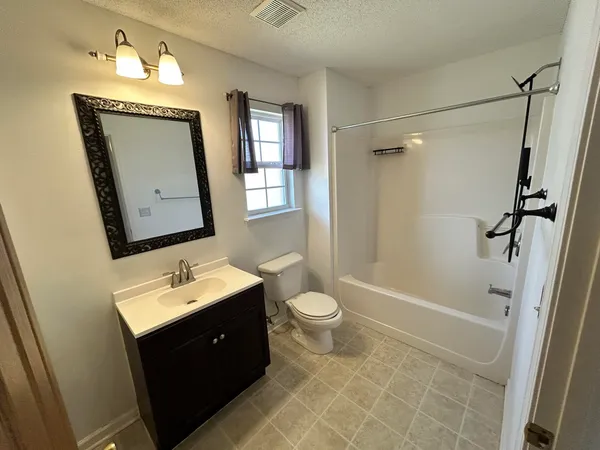 a bathroom with a double vanity sink toilet mirror and shower