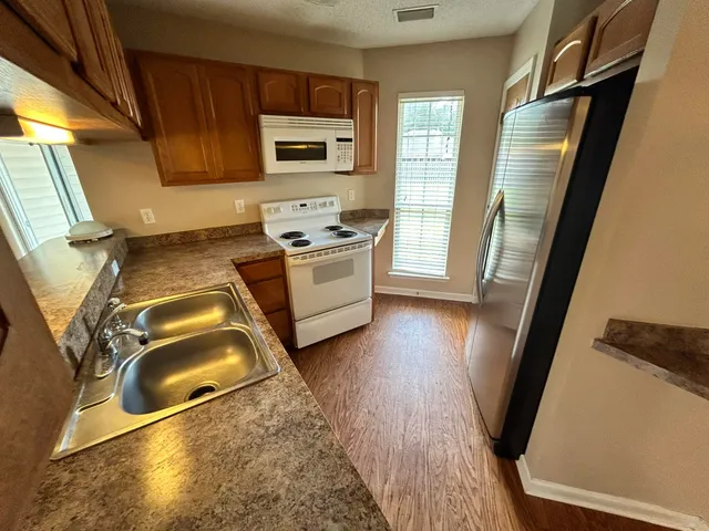 a kitchen with sink refrigerator and stove