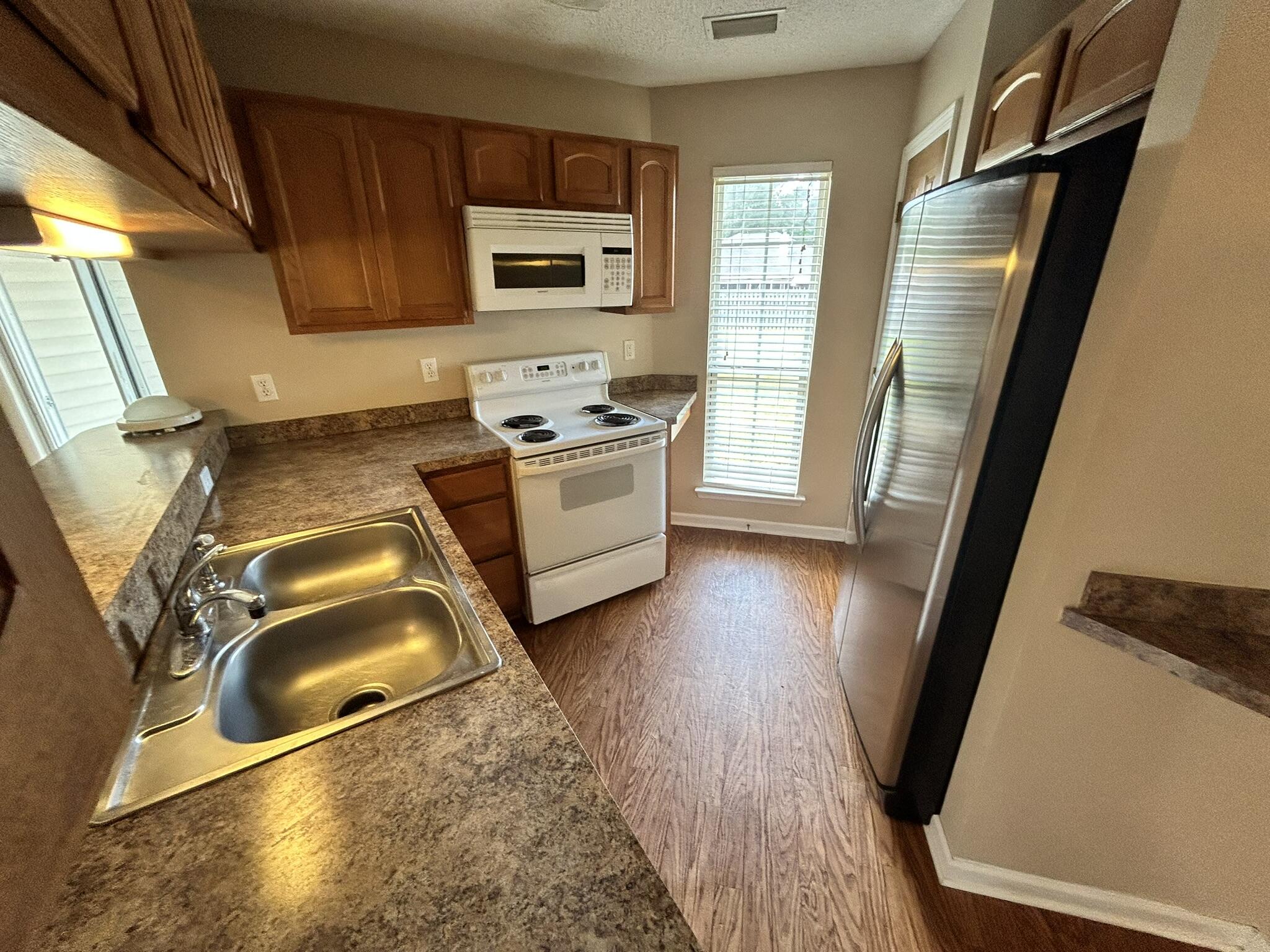 2175 Hagood Loop Crestview, FL 32536 - Photo 4 of 15 a kitchen with sink refrigerator and stove