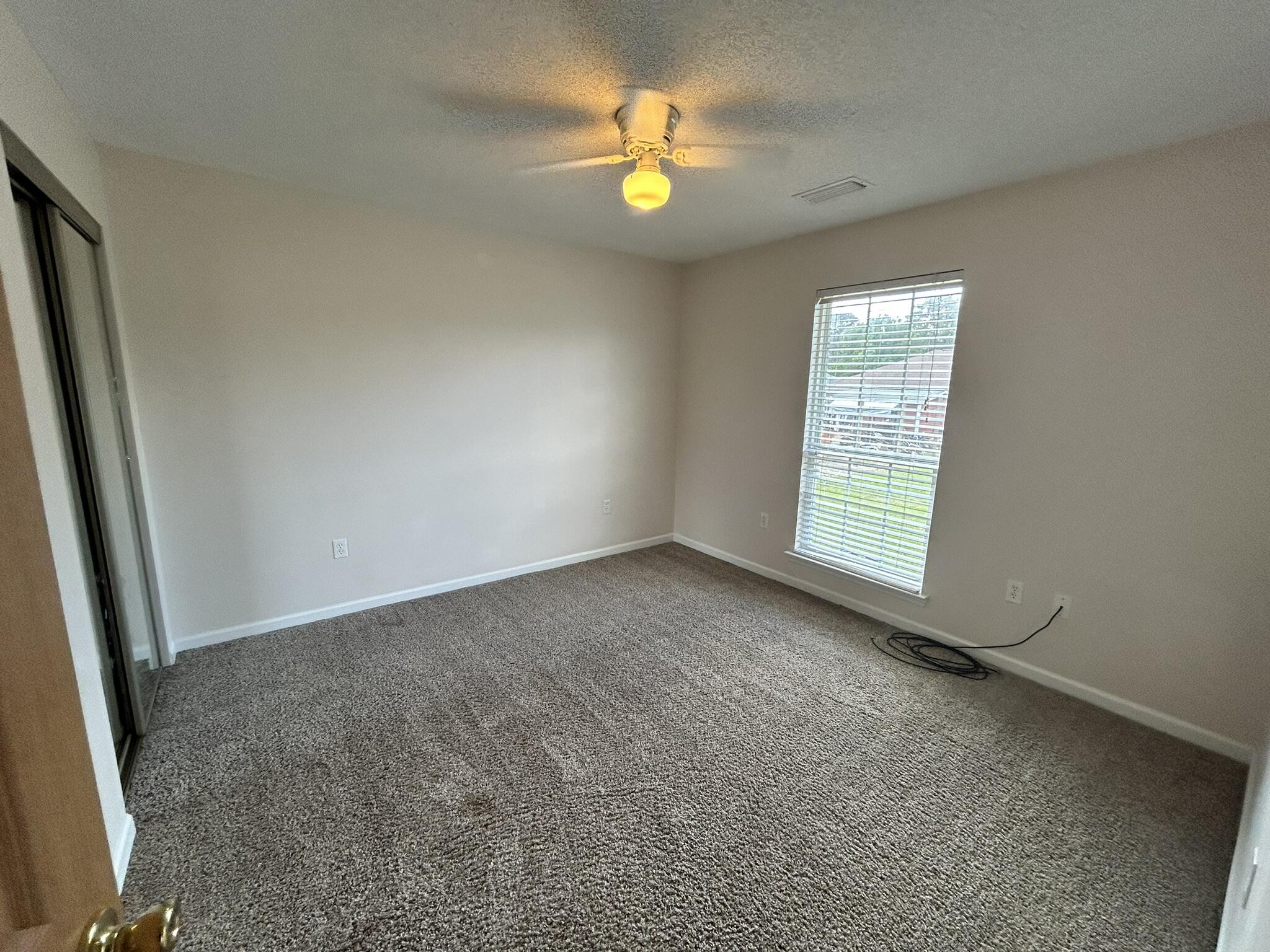 2175 Hagood Loop Crestview, FL 32536 - Photo 7 of 15 an empty room with window and a fireplace