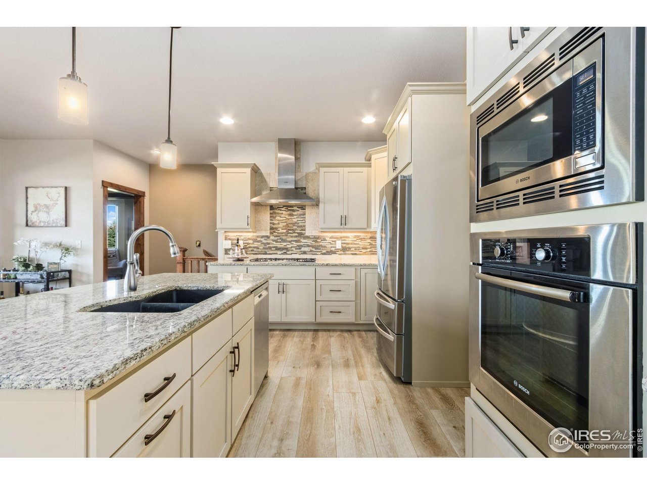 7982 Rising Sun Court Windsor, CO 80550 - Photo 12 of 48 a kitchen with stainless steel appliances granite countertop a sink stove and refrigerator