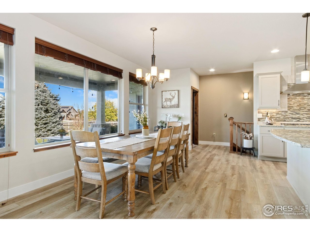 7982 Rising Sun Court Windsor, CO 80550 - Photo 13 of 48 a view of a dining room and livingroom with furniture wooden floor a chandelier