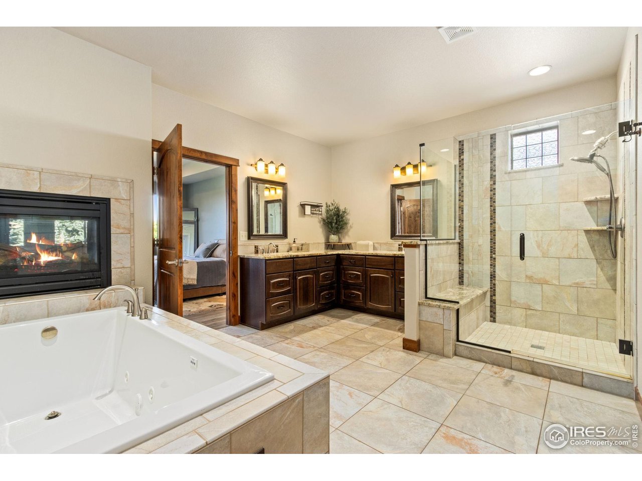 7982 Rising Sun Court Windsor, CO 80550 - Photo 16 of 48 a bathroom with a tub sink and mirror