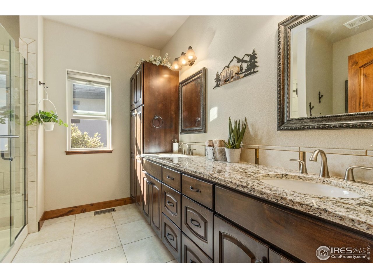 7982 Rising Sun Court Windsor, CO 80550 - Photo 19 of 48 a bathroom with a granite countertop sink a mirror and vanity