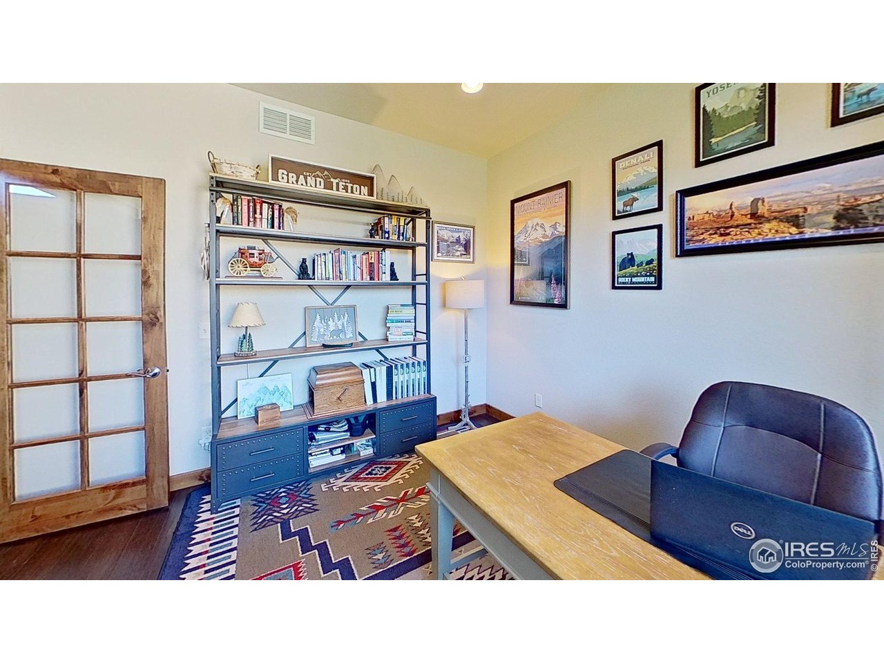 7982 Rising Sun Court Windsor, CO 80550 - Photo 21 of 48 a living room with furniture and book shelf