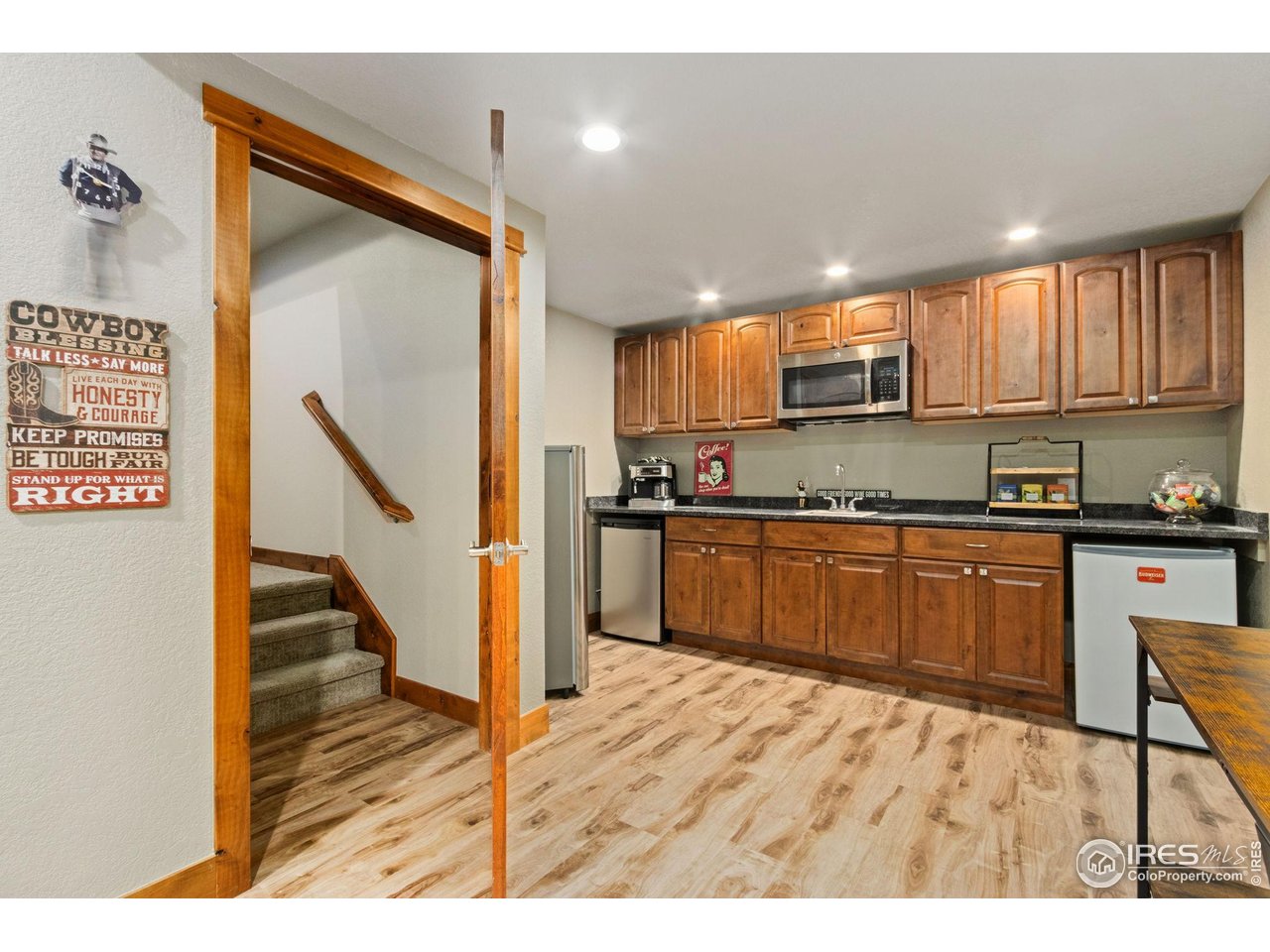 7982 Rising Sun Court Windsor, CO 80550 - Photo 26 of 48 a kitchen with stainless steel appliances granite countertop a refrigerator and a stove top oven