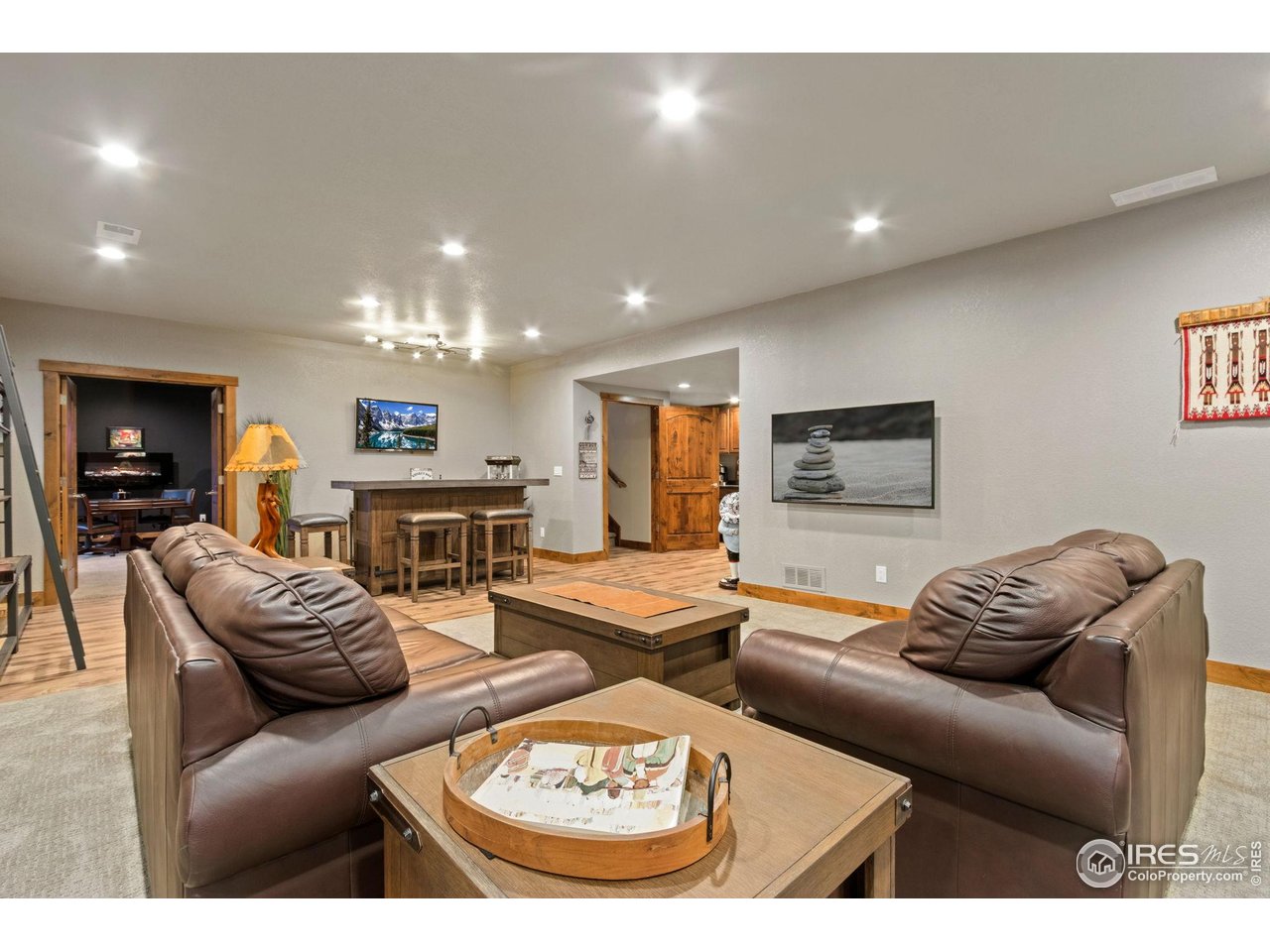 7982 Rising Sun Court Windsor, CO 80550 - Photo 28 of 48 a living room with furniture and a flat screen tv