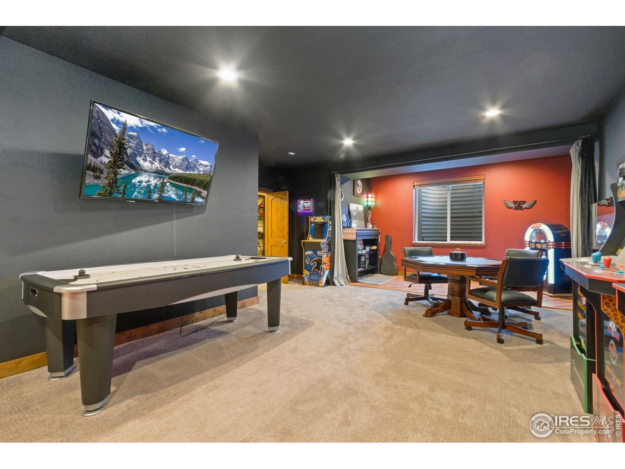 7982 Rising Sun Court Windsor, CO 80550 - Photo 32 of 48 a living room with furniture pool table and a flat screen tv