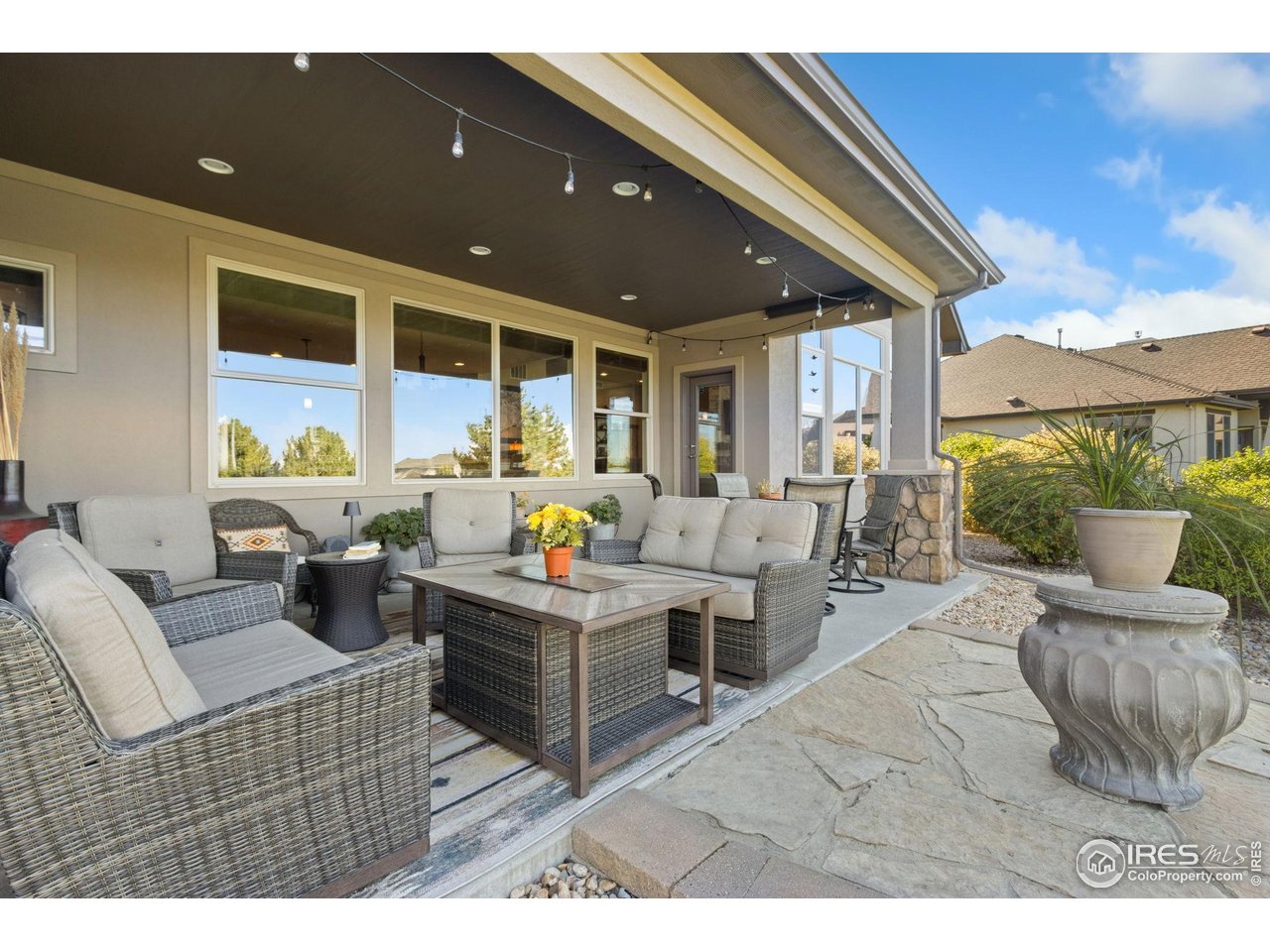 7982 Rising Sun Court Windsor, CO 80550 - Photo 36 of 48 a living room with furniture and a large window