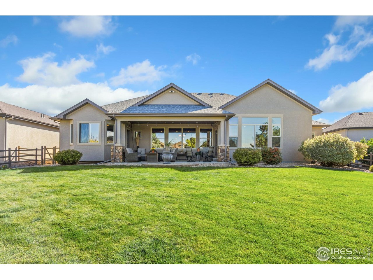 7982 Rising Sun Court Windsor, CO 80550 - Photo 37 of 48 a front view of a house with a garden
