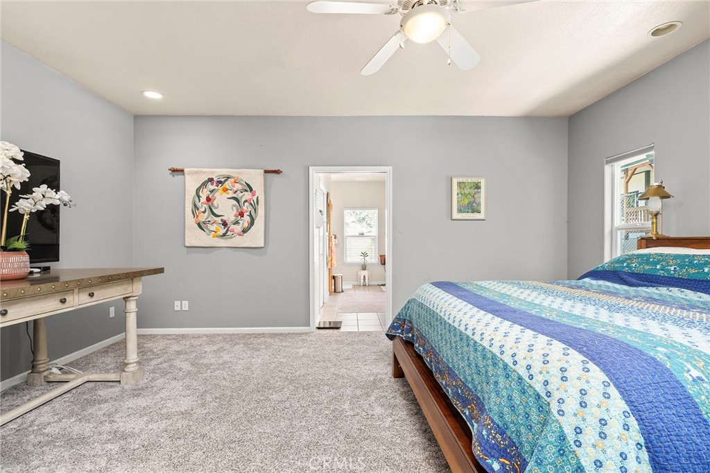2262 Honey Run Road Chico, CA 95928 - Photo 15 of 74 a bedroom with a bed and a chandelier