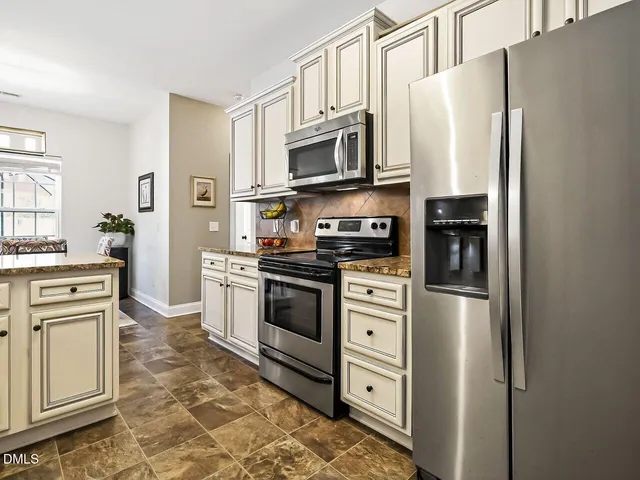 a kitchen with stainless steel appliances a refrigerator stove and microwave