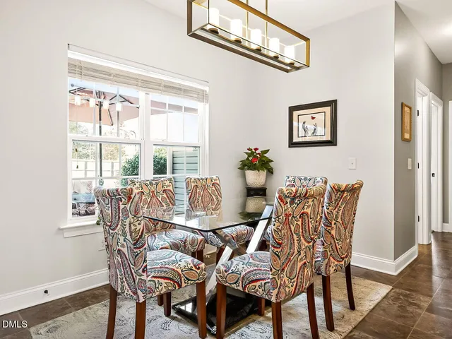 a view of a dining room with furniture and a chandelier