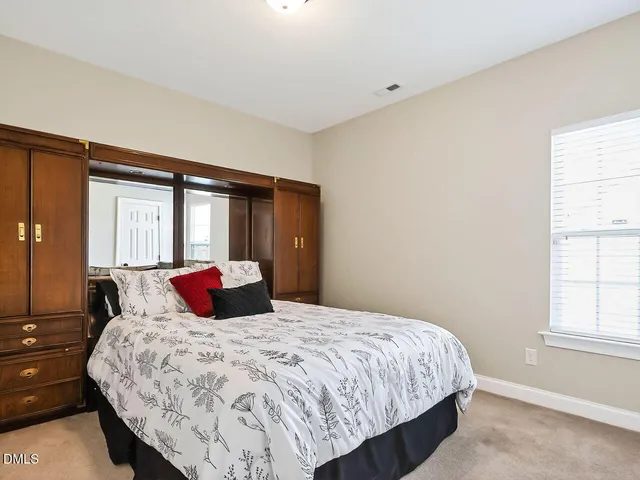 a bedroom with a large bed and a window