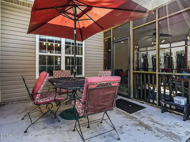 a backyard of a house with table and chairs