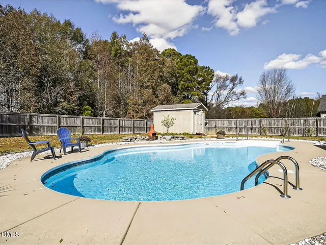a view of a swimming pool with a lounge chairs