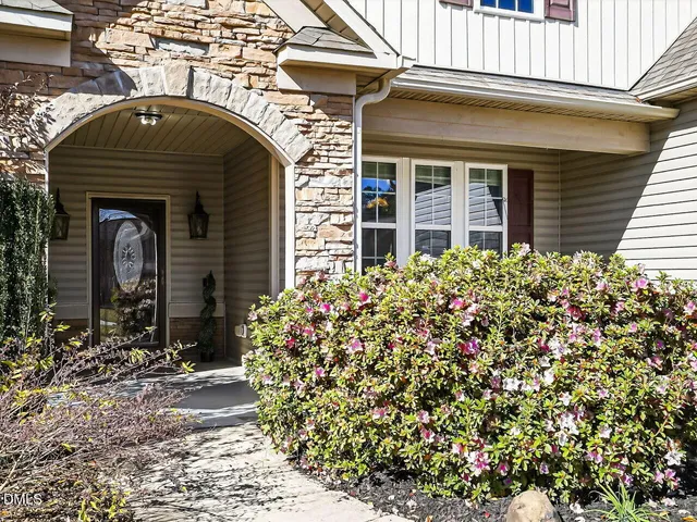 a front view of a house with plants