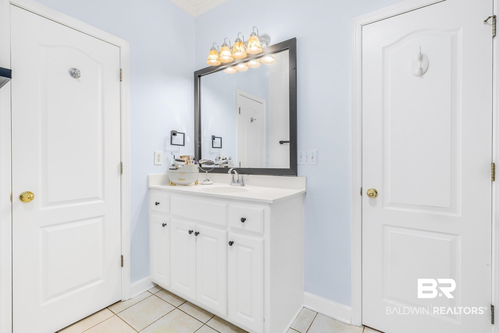 10603 Old Stage Road Stockton, AL 36579 - Photo 23 of 34 Bathroom with light tile patterned floors, vanity, and ornamental molding