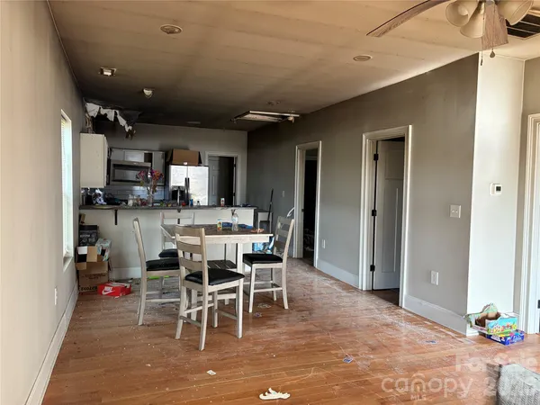 a dining area with stainless steel appliances kitchen island granite countertop a dining table chairs and granite counter tops