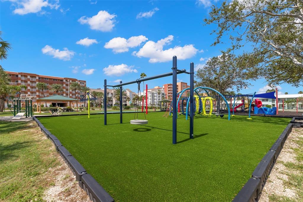 16333 Gulf Boulevard, Unit 113 Redington Beach, FL 33708 - Photo 29 of 40 a view of a park with swings and slides