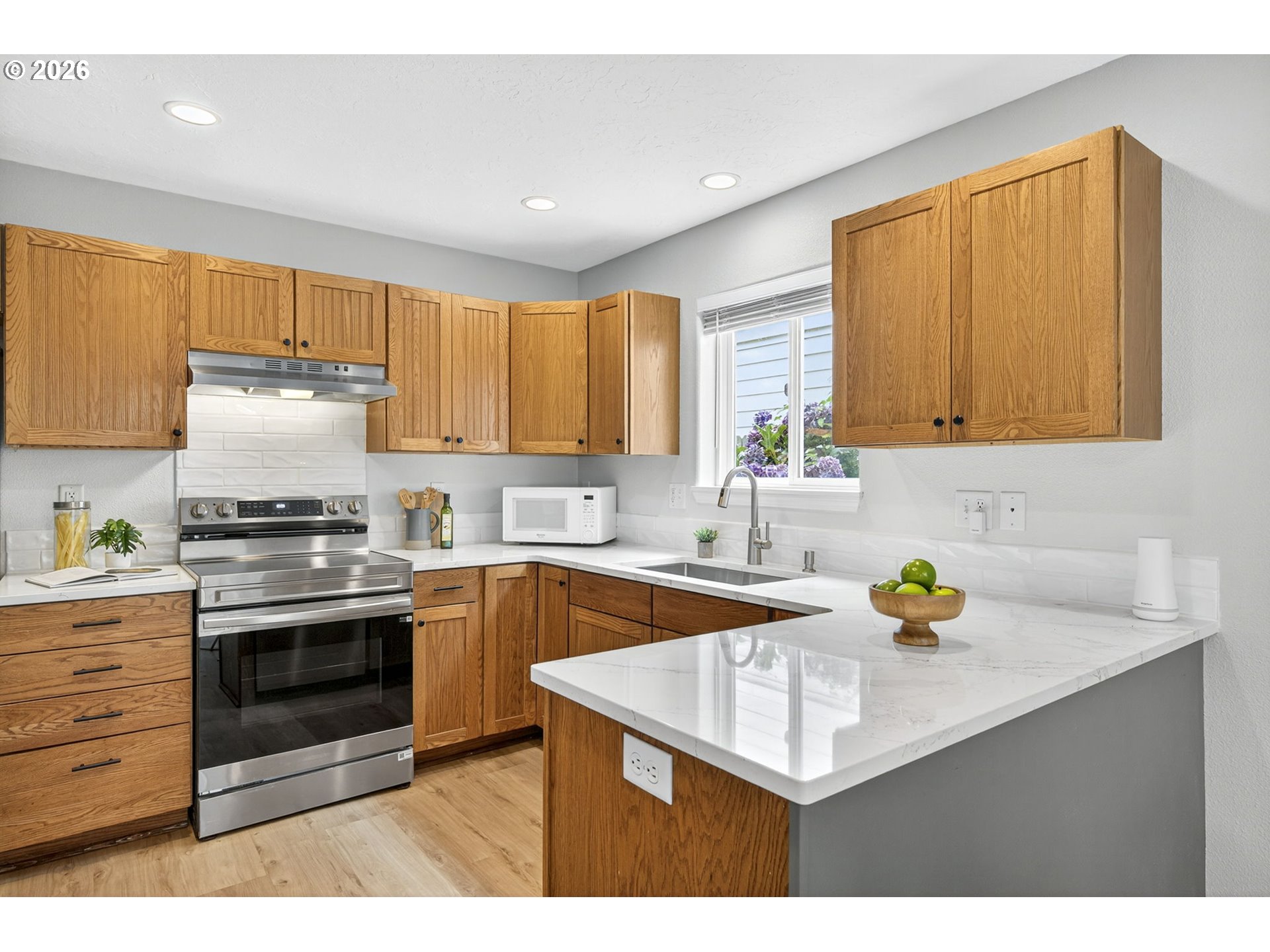 929 Northwest Spring Street Newport, OR 97365 - Photo 16 of 46 a kitchen with stainless steel appliances granite countertop a sink stove and cabinets