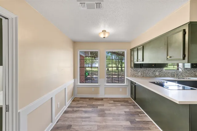 a view of a kitchen with a sink and windows