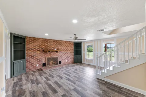 wooden floor in an empty room with a fireplace