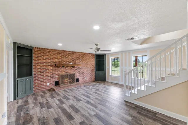 wooden floor in an empty room with a fireplace
