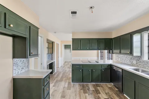 a kitchen with a sink and cabinets