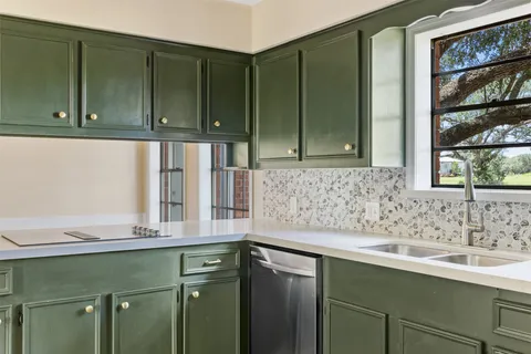 a kitchen with a sink and cabinets