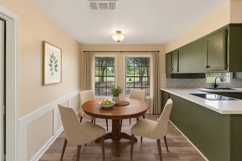 a kitchen with a table and chairs in it