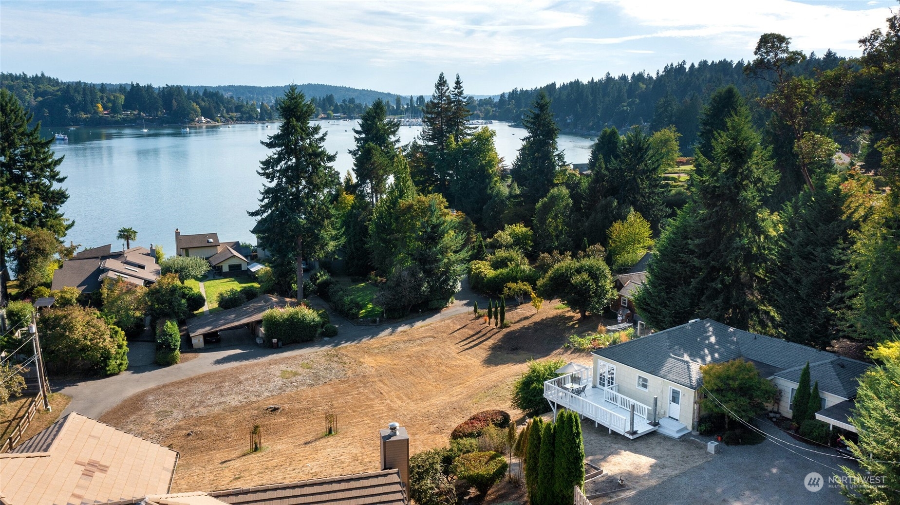 9917 Southwest Quartermaster Drive Vashon, WA 98070 - Photo 1 of 1 an aerial view of a house with outdoor space and lake view in back